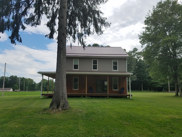 Relax on the  wrap around front deck of this scenic farmhouse. 