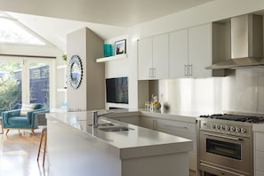 the open plan kitchen with breakfast bar