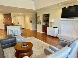 Comfortable living room with leather furniture and raised ceiilng.