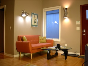 MCM loveseat, classic Noguchi table and retro wall sconces.