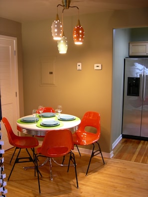 Dining area with vintage mid-mod lighting and Krueger Fiberglass chairs.