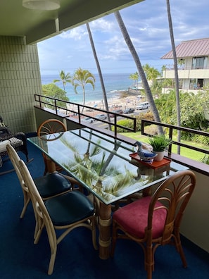 Outside dining area with view of the beach, pool and mountains.