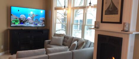 Living Room with bluetooth equipped entertainment center & surround sound.