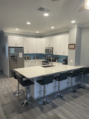 Completely remodeled kitchen with quartz countertops and stainless steel