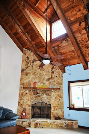 Unique,spacious family room with huge stone fireplace opens up to kitchen .