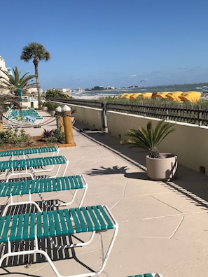 Extra large patio with lounge chairs and tables. 