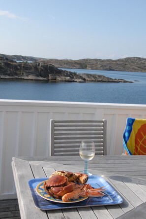 Enjoy a glass of wine and some shellfish treats on the veranda.