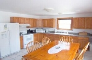 Kitchen-elec. stove, fridge, microwave, coffee pot, blender, pots/pans, dishes.