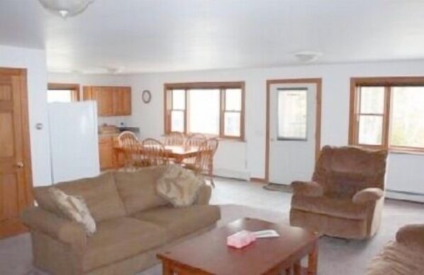Living room into kitchen. Recliner has been replaced with reclining love seat.