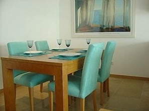 Dining area with its gorgeous turquoise chairs