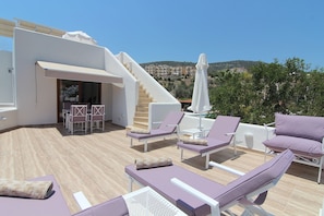 "The Terrace" lower private roof terrace with sun beds and dining table