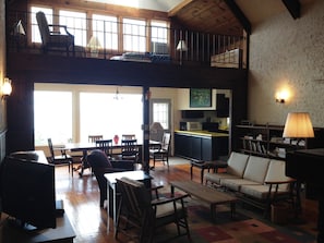 The great room and loft are flooded with light and look out over the lake.