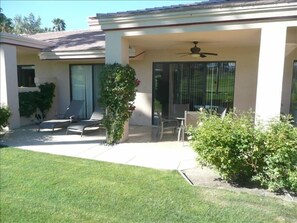 Golf course side patio with patio furniture and southern exposer