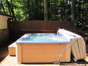 Hot tub on the back deck with a river view.