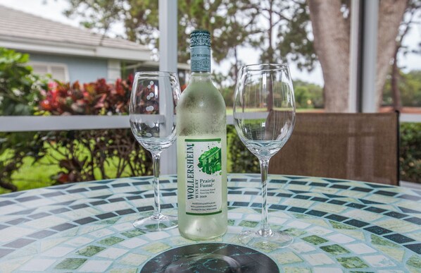 Enjoy a drink and the view from the screened lanai.
