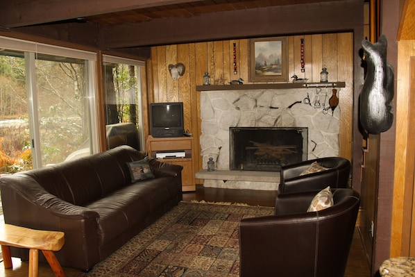 Living Room is bright & cheery with windows looking out across the River