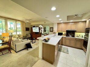 Kitchen, into the living room with Art Frame flat screen TV and surround sound.