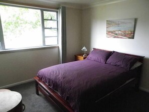 The cosy downstairs bedroom has access to a separate living area and bathroom.