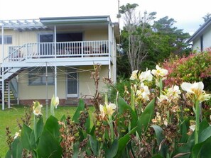 View of the back of the house and the deck.  The yard has plenty of play room.