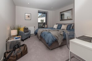 Luxury master bedroom with super king size bed facing tranquil garden patio.