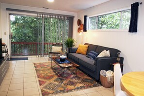 Spacious living room with private balcony and view of the forest
