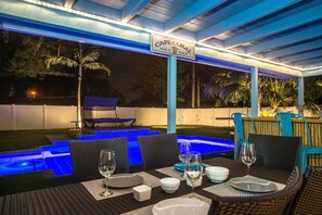 View of lit backyard from lanai.