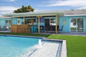 Tiki bar and lanai with 8-person dining table