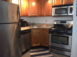 Modern kitchen with stainless steel appliances and granite counter