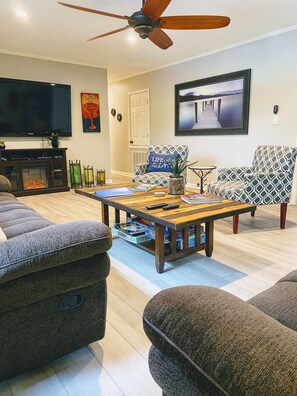 Huge living room with 70 inch flat screen and  fireplace