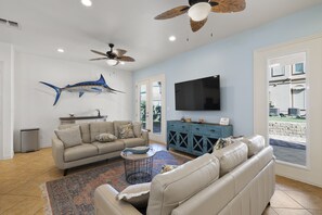Large flat screen TV in the living area. Access to the patio and NEW HOT TUB is just through these doors!