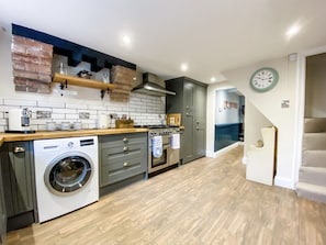 Spacious kitchen with underfloor heating leading through to the dining room