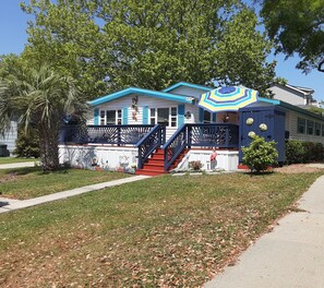 Front deck with seating, umbrellas, dining and outdoor shower.