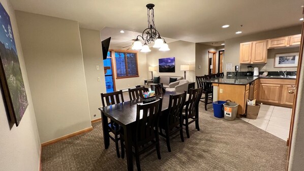 View of dining room, kitchen, and living room with fireplace.