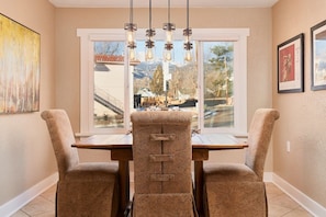 Dining room has unique locally sourced prints and a wonderful Pikes Peak view past the vintage Apache sign, a West Side landmark.