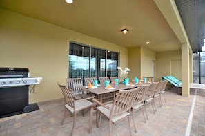 Patio table with 8 chairs and BBQ gas grill.