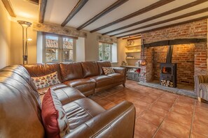 Mayes Cottage, Brancaster: Sitting room with feature fireplace and wood burning stove