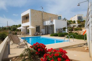 Garden with barbecue, seating area, sun loungers and private pool