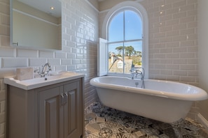 First floor: Stunning bathroom with roll top bath and views of the estuary