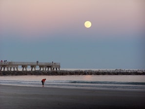 Moon over the cocoa beach pier at sunset