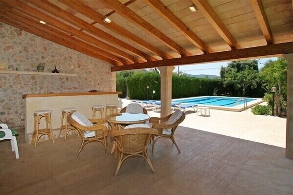 Covered terrace next to pool, jacuzzi and sauna