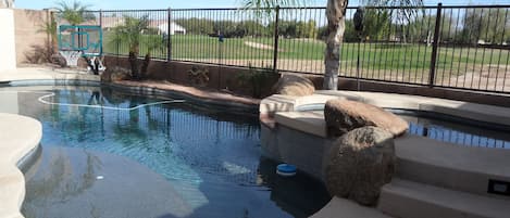 Heated pebble tec pool with golf course view.
