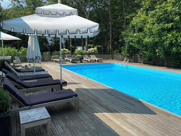 Sunny pool area with 20x40 heated pool (2024 renovation) with 12 lounge chairs.