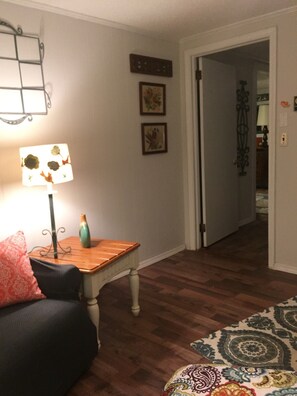 Spacious Master bedroom with a queen bed, dresser and love seat