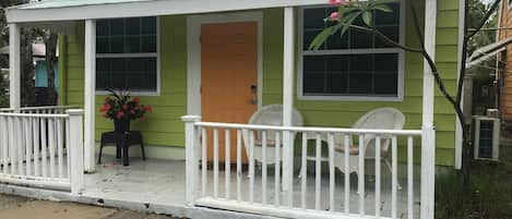 The front of the Cottage, with its porch for enjoying coffee  or cocktails