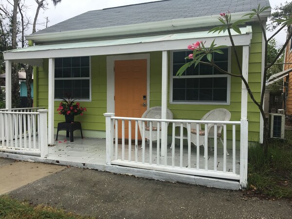 The front of the Cottage, with its porch for enjoying coffee  or cocktails