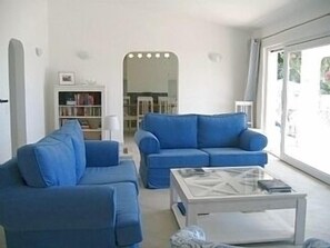 A clean modern, sitting room with large doors onto the terrace and that view!