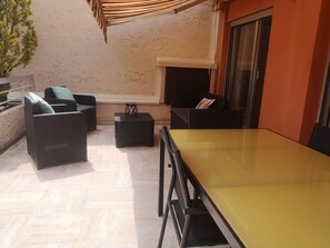 Outdoor dining and lounge areas on the terrace.