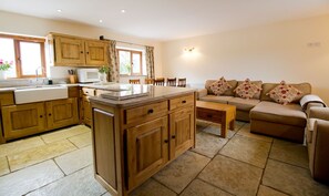 Living area with stone floors and flat-screen television. 