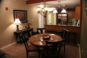 Dining area.There are two extra chairs for the dining table. Bar seats three.