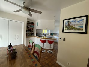 Eating Table seating four persons with two counter top stools